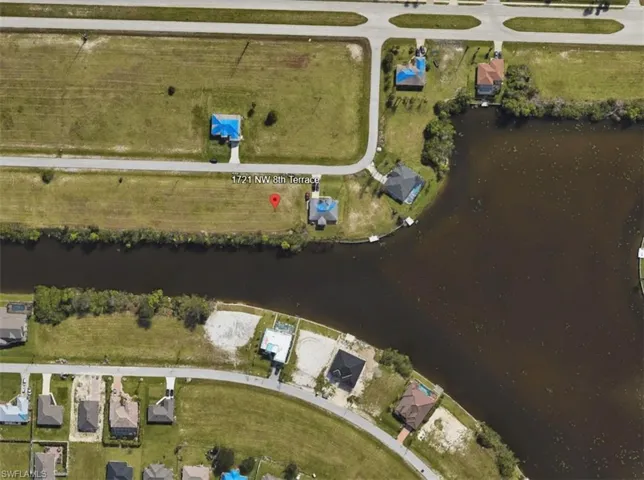 View of property location featuring a nearby body of water and nearby suburban area