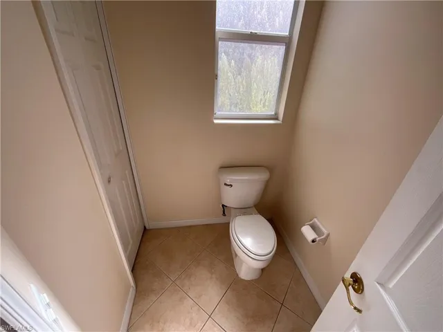 Bathroom with tile patterned floors and toilet