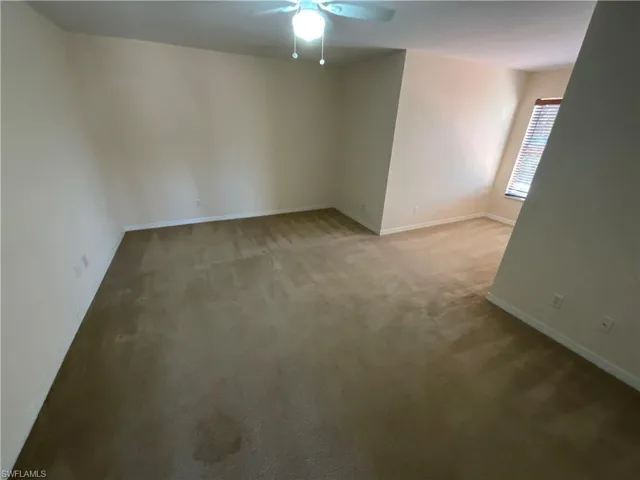 Spare room with carpet flooring and ceiling fan