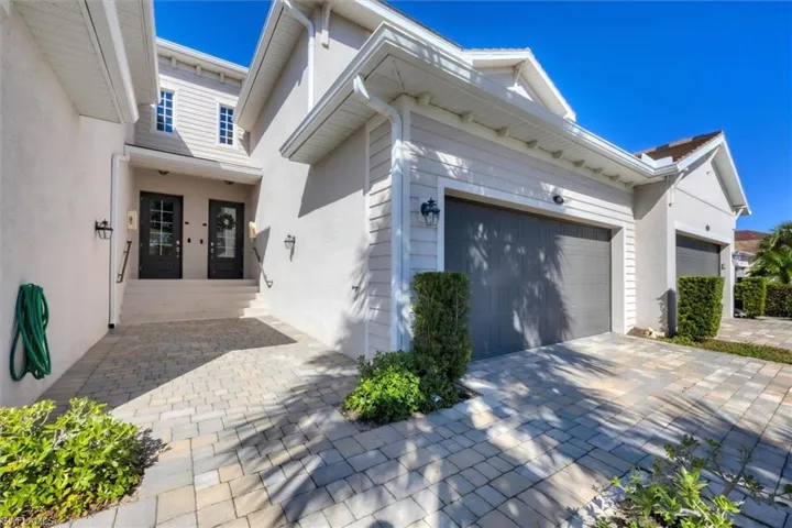 View of side of home featuring stucco siding and driveway