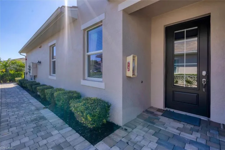 Entrance to property with stucco siding
