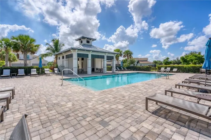 Community pool with a patio area and a gazebo
