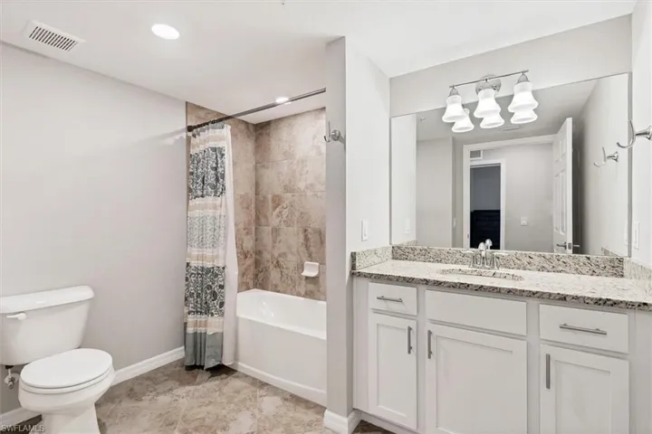 Full bath with shower / bathtub combination with curtain and vanity