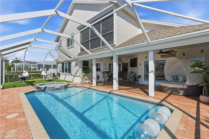 Relaxing pool / spa with a patio, a lanai, and a sunroom
