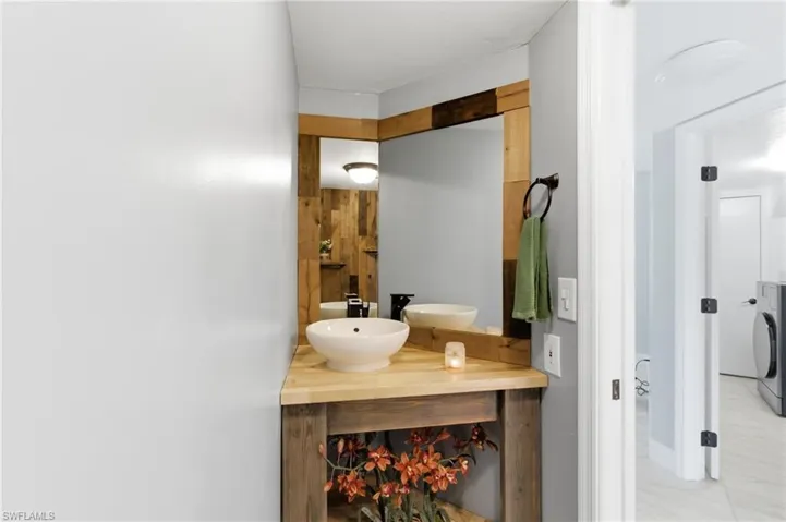 Bathroom with double vanity and washer / dryer