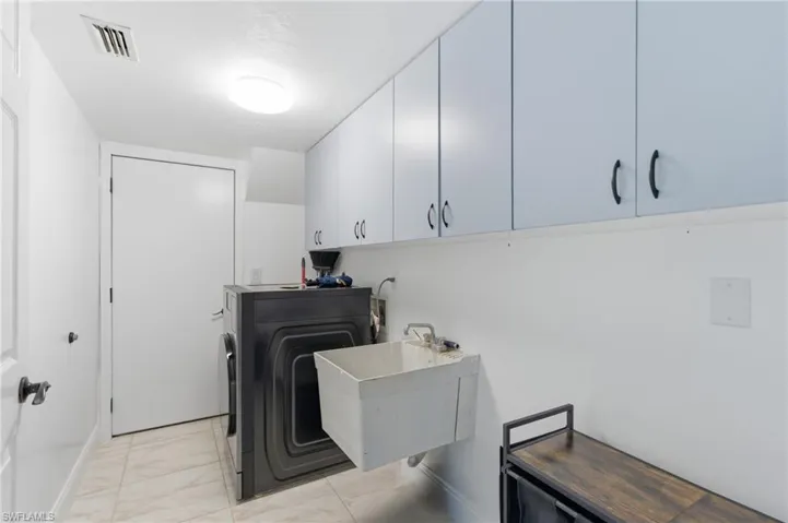 Laundry room featuring washer / dryer and cabinet space