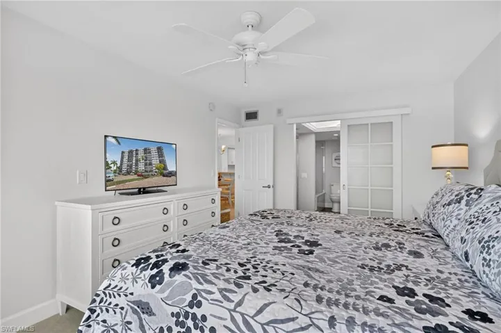 Bedroom featuring light colored carpet and a ceiling fan