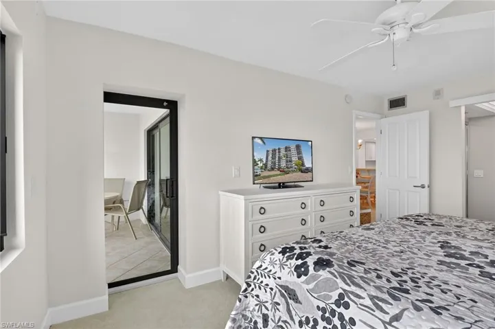 Bedroom with light colored carpet and ceiling fan