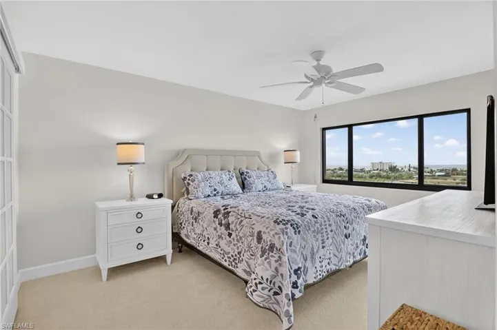 Bedroom featuring light colored carpet and ceiling fan