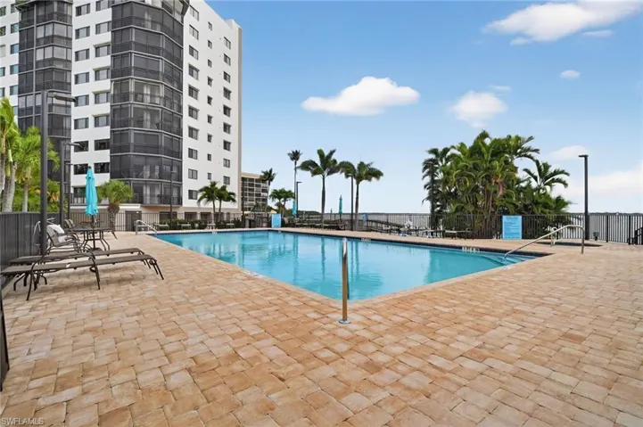 Community pool with a patio
