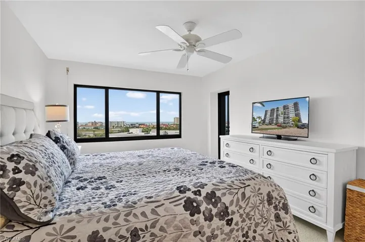 Bedroom featuring a ceiling fan and light colored carpet