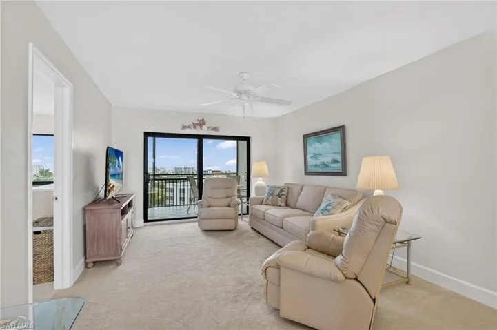 Living room featuring light carpet and ceiling fan