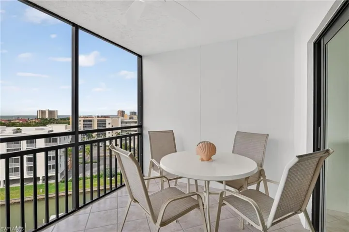 Balcony featuring a sunroom and a view of city