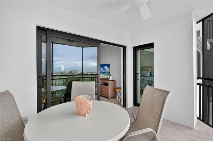 Dining space with a ceiling fan and light tile patterned floors