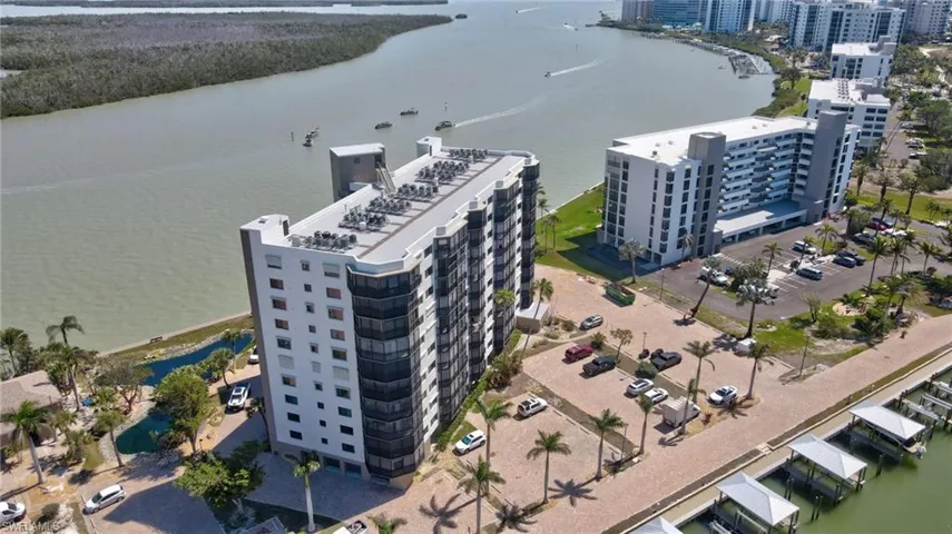 Aerial view of a nearby body of water and apartment complex / building