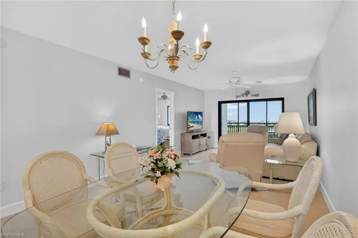 Dining room featuring ceiling fan and suspended lighting