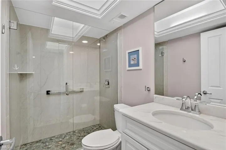 Full bathroom with vanity and a marble finish shower