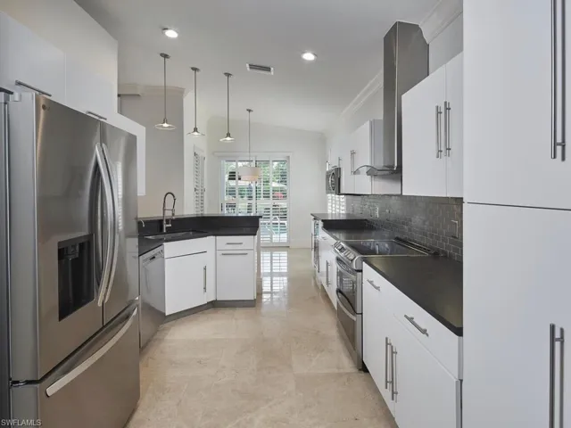 Kitchen with stone countertops and stainless steel appliances