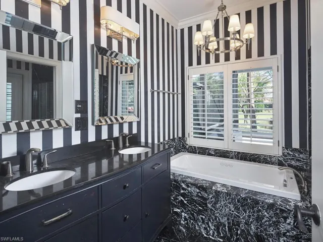 Primary Bathroom with dual vanities, walk-in shower and jetted tub