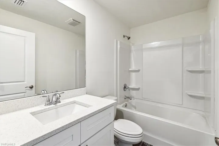Full bathroom with toilet, shower / tub combination, and vanity