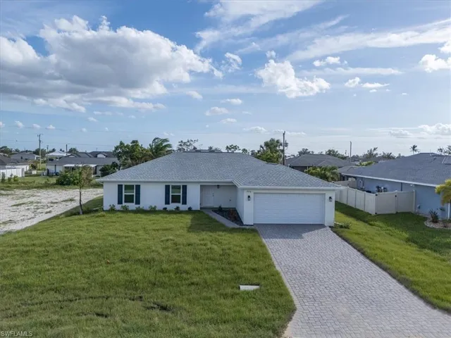 Single story home with a front lawn and a garage