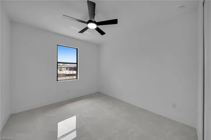Spare room featuring baseboards and ceiling fan