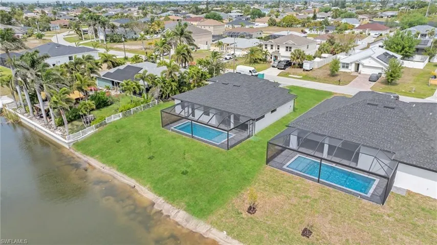 Aerial view featuring a residential view and a water view