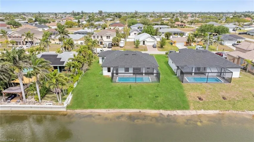 Drone / aerial view with a residential view and a water view