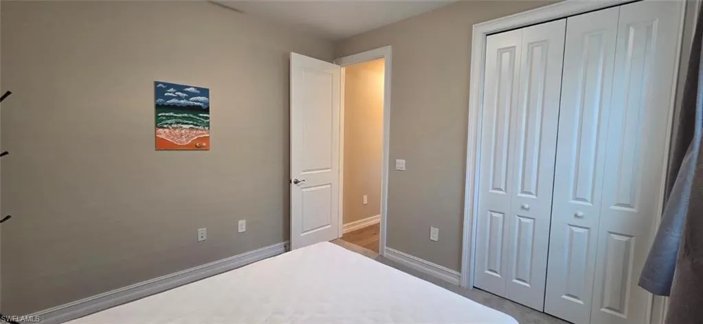 Bedroom with baseboards and a closet