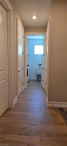 Hallway featuring baseboards and light wood-type flooring