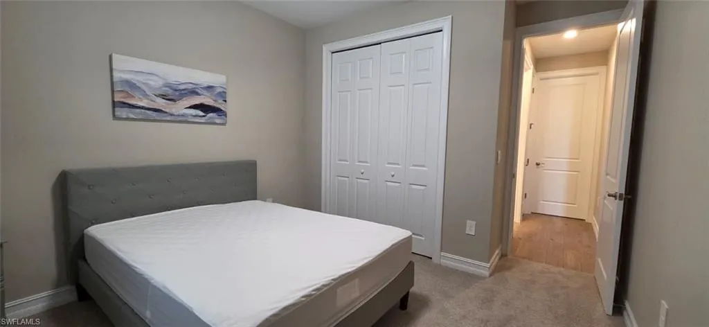 Bedroom featuring a closet and light carpet