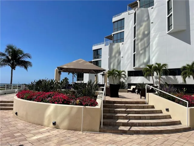 More paved patio and terrace between pool level and the gazebo