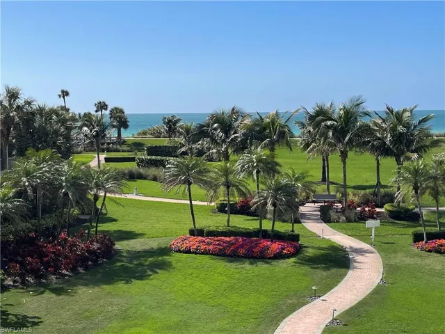 View of the beach from community patio and sidewalk to the beachside promenade and beach