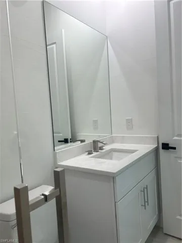 Bathroom featuring vanity and toilet