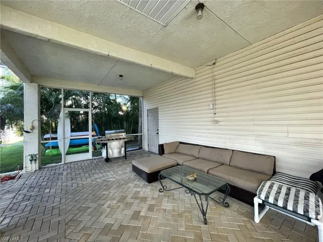 View of patio featuring outdoor furniture and a grill
