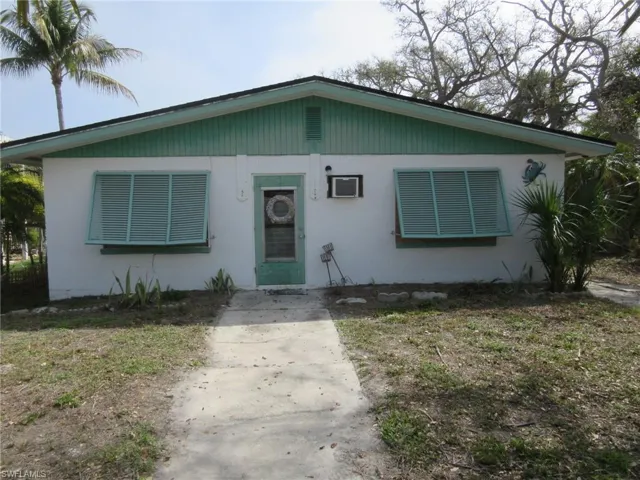 Bungalow-style home with stucco siding