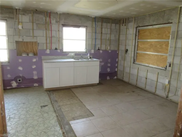 Kitchen with white cabinetry and light countertops