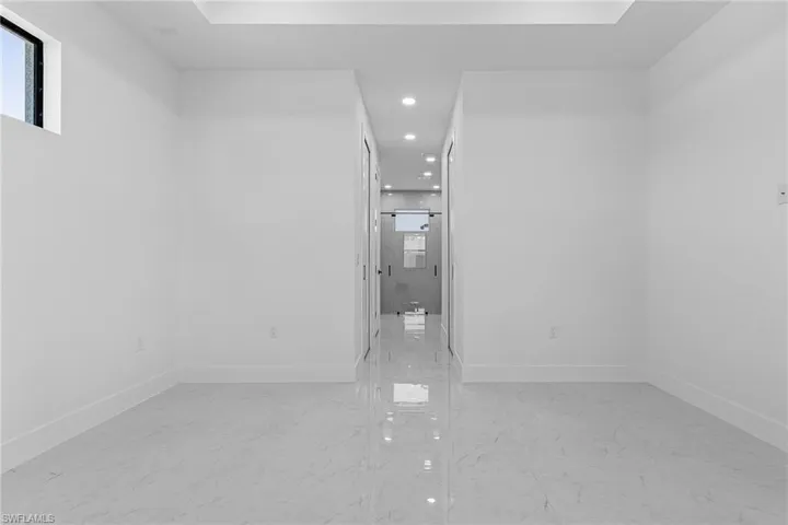 Unfurnished room with baseboards, marble finish floor, and recessed lighting