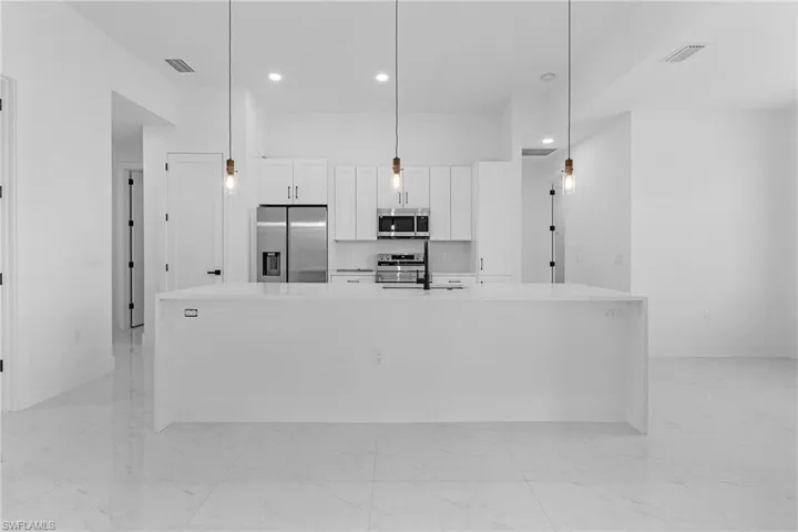 Kitchen with marble finish floor, visible vents, and appliances with stainless steel finishes