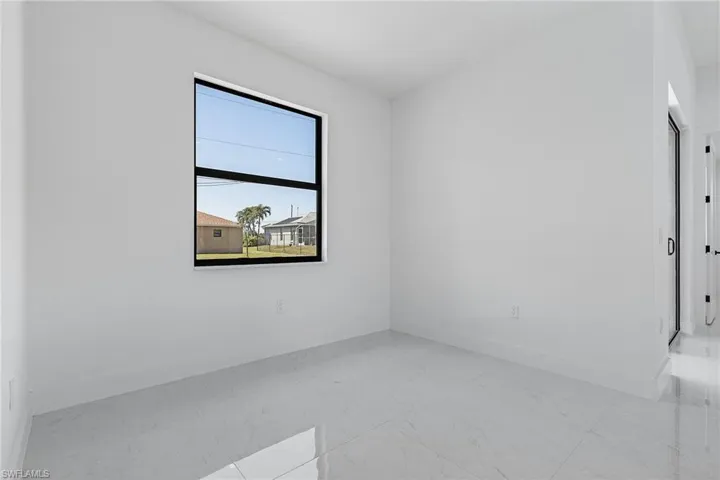 Unfurnished room with baseboards and marble finish floor
