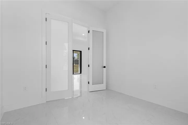 Spare room with marble finish floor and baseboards