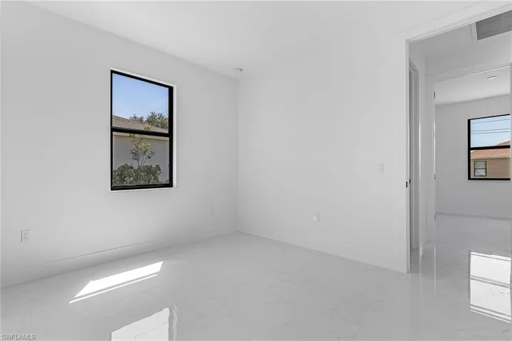 Empty room featuring marble finish floor, baseboards, and visible vents