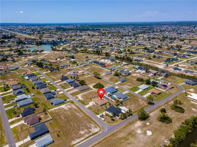 Birds eye view of property with a water view and a residential view
