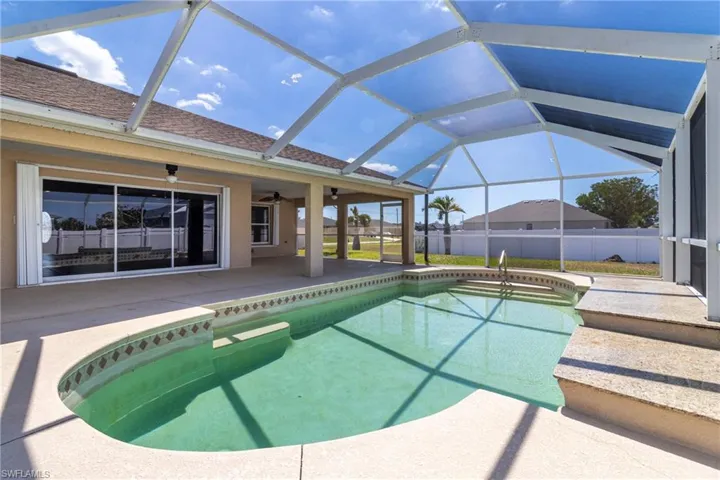 View of pool with ceiling fan, a fenced in pool, fence, and a patio area