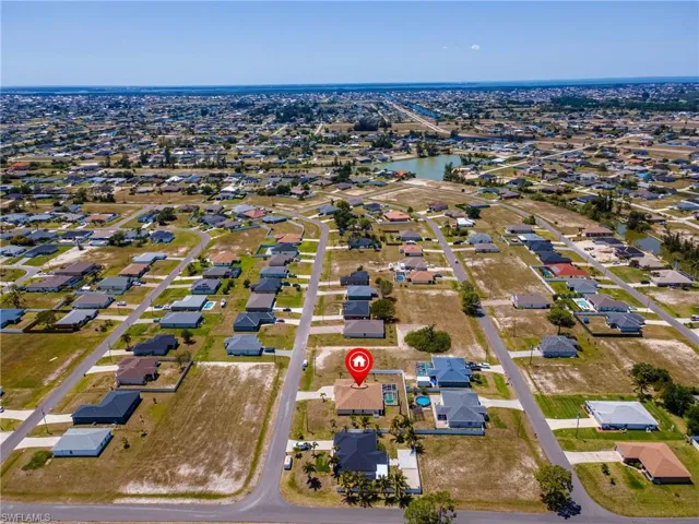 Birds eye view of property featuring a water view and a residential view