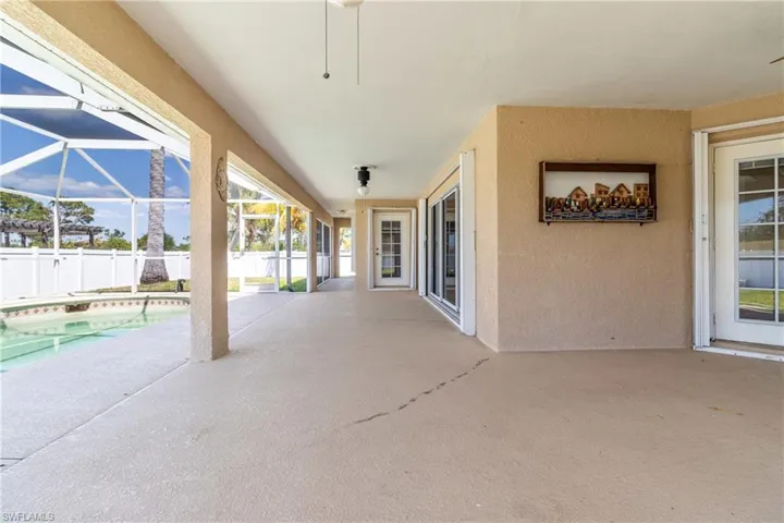 View of patio / terrace with a fenced in pool, glass enclosure, and fence