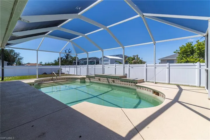 View of pool featuring a patio, a fenced backyard, a fenced in pool, and glass enclosure