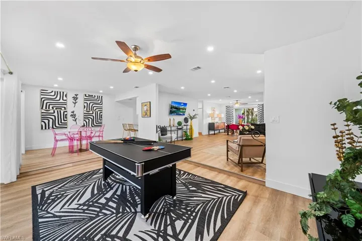 Open-concept interior featuring recessed lighting, a ceiling fan, and wood-finish flooring