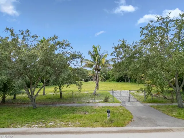 View of community featuring a gate and driveway