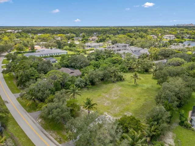 Aerial overview of property's location with a tree filled landscape